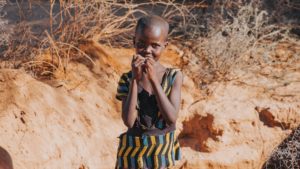 Girl from Kenya eats a snack